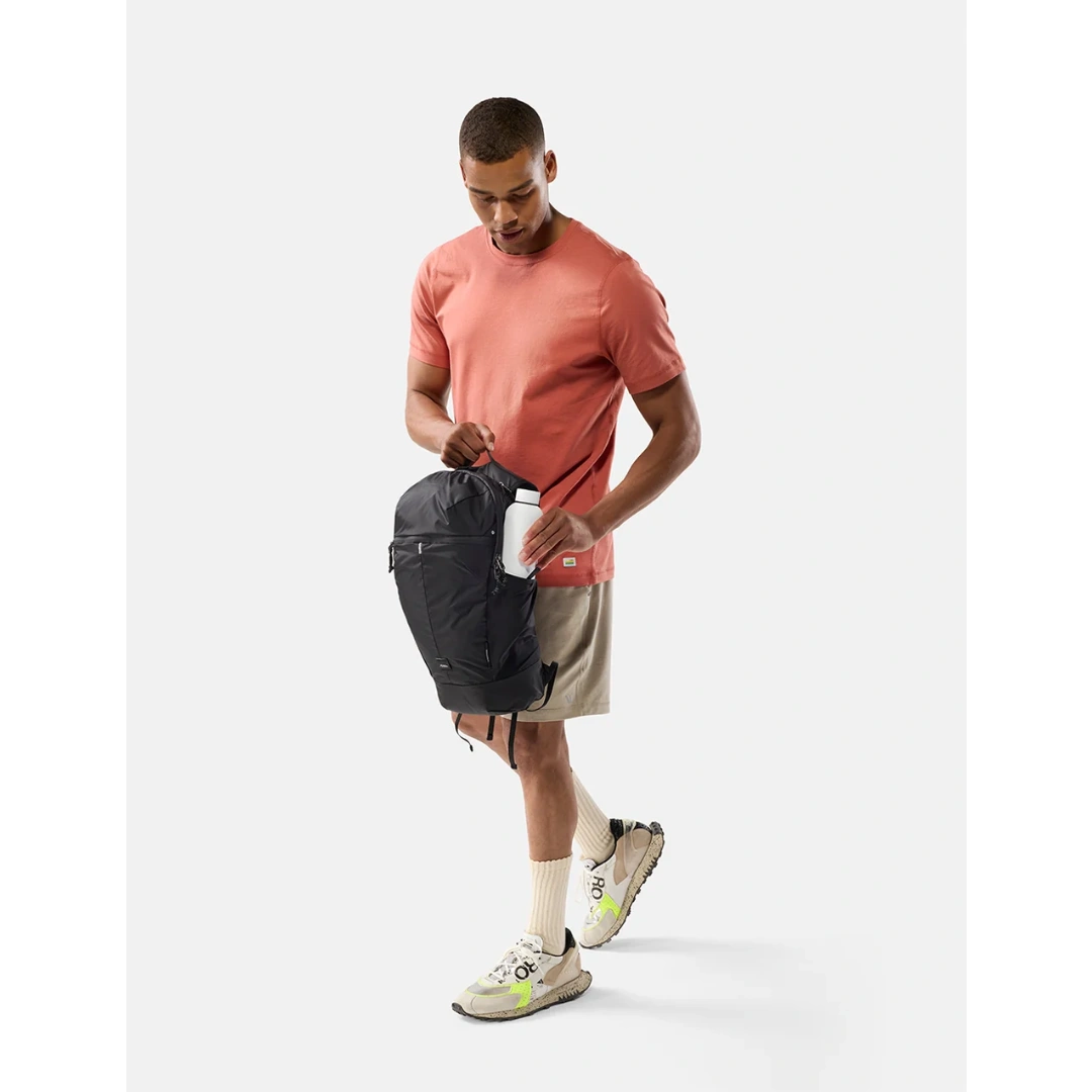 Mand med Matador 18L sort packable Daypack, med vandflaske i sidelomme